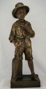 A Goldscheider Figure of a Boy Standing by a Mile Post with one hand in pocket. 23.5 inches tall.