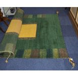 Indian Thick Pile Wool Rug, green ground with geometric design and yellow square centre.