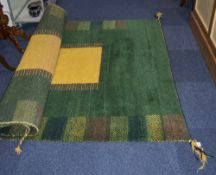 Indian Thick Pile Wool Rug, green ground with geometric design and yellow square centre.