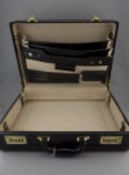 A Modern Black Leather Attache Case with Fitted Stationary Interior and Combination Locks.