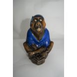 Royal Doulton Early 20thC Monkey Figure wearing a blue night cap and night gown in a sitting