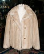 Ladies Faux Fur Short Jacket with slit pockets and rever collar.