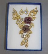 Floral Crystal and Gilt Statement Necklace and Drop Earrings, a V shaped, sectional, filigree floral
