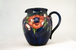 W Moorcroft Signed Globular Jug 'Clematis' design on blue ground circ 1940's 6.5 inches high.