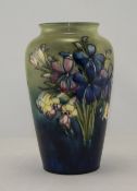 W. Moorcroft Signed Vase ' Spring Flowers ' on Blue/Green Ground. Label to Base, Reads Potters to H.