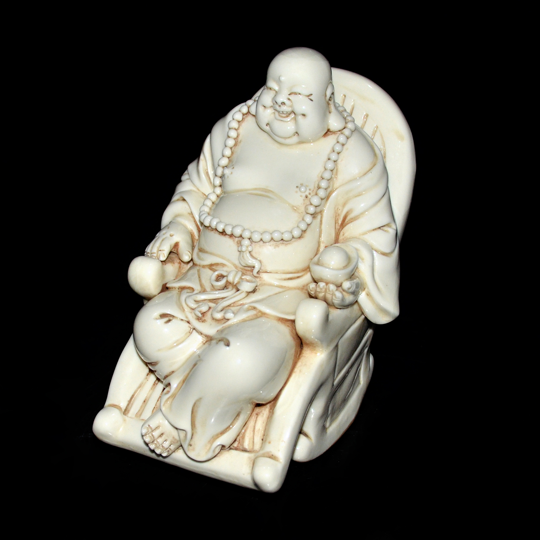 白瓷塑雕彌佛送財搖椅賞件 A White Porcelain Carved Maitreya on a Rocking Chair with Nugget Height: 6 in (15.2