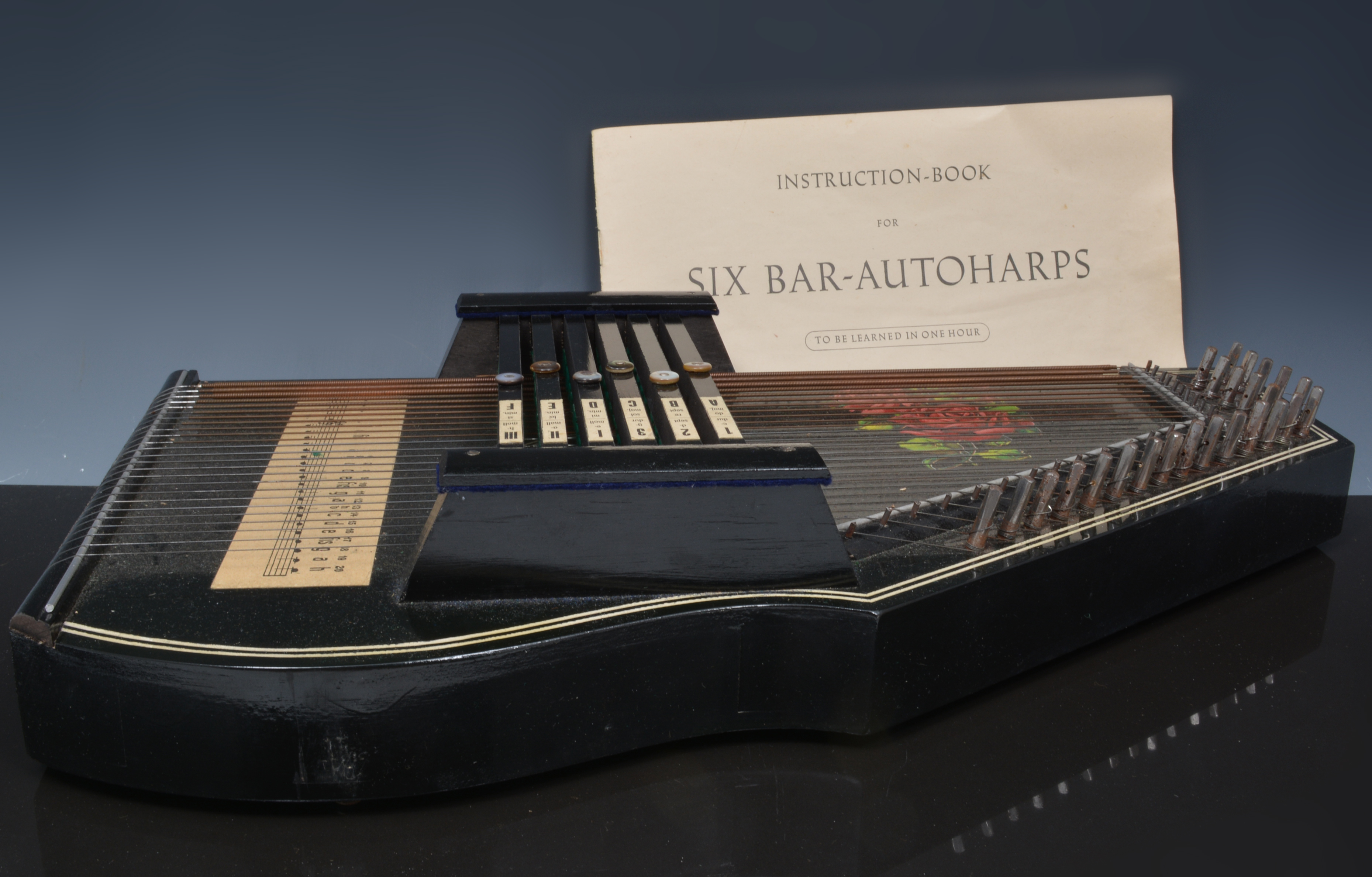 Six bar autoharp, in a cloth covered cas