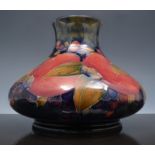 A William Moorcroft "Pomegranate" vase, circa 1914, the squat body decorated with a broad band of