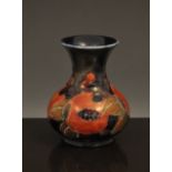 A William Moorcroft "Pomegranate" vase, circa 1920, with short flared neck, initialled in blue,