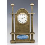 An Arts and Crafts mantel clock, circa 1900, in the style of George Walton, the brass case with