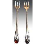 A pair of silver plated pickle forks, in