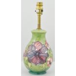 Moorcroft table lamp, with floral decoration to a green ground, approximately 20cm.