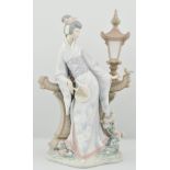 Lladro figure of a Japanese lady, dressed in kimono, standing along side a lamp with a bird,