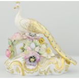 Royal Crown Derby figure, modelled as peacock, seated on a floral encrusted Rococo base, height