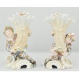 Pair of Continental cornucopia vases, modelled as children holding flowers, with stylised flower