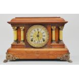 Stained wood mantle clock, with a brass dial, by Seth Thomas, mounted on brass feet,