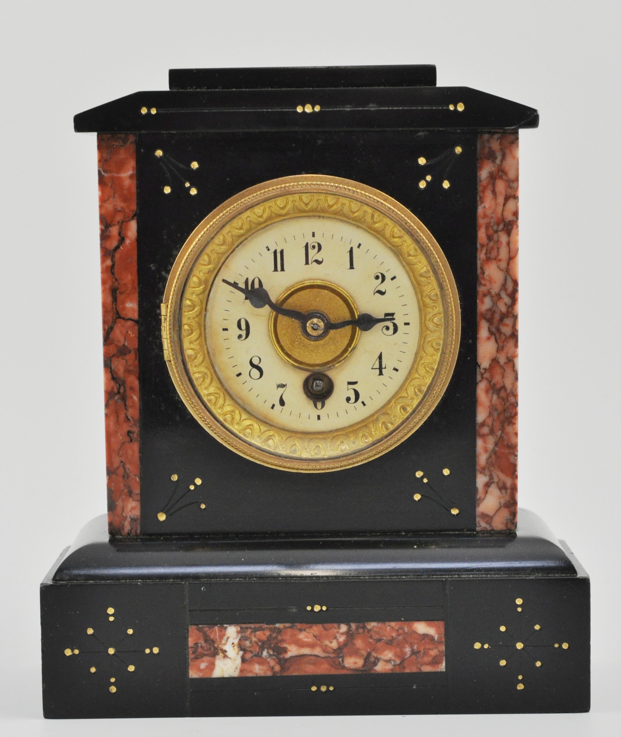 Small Victorian marble mantel clock, with stylised decoration to a plinth base, brass dial,