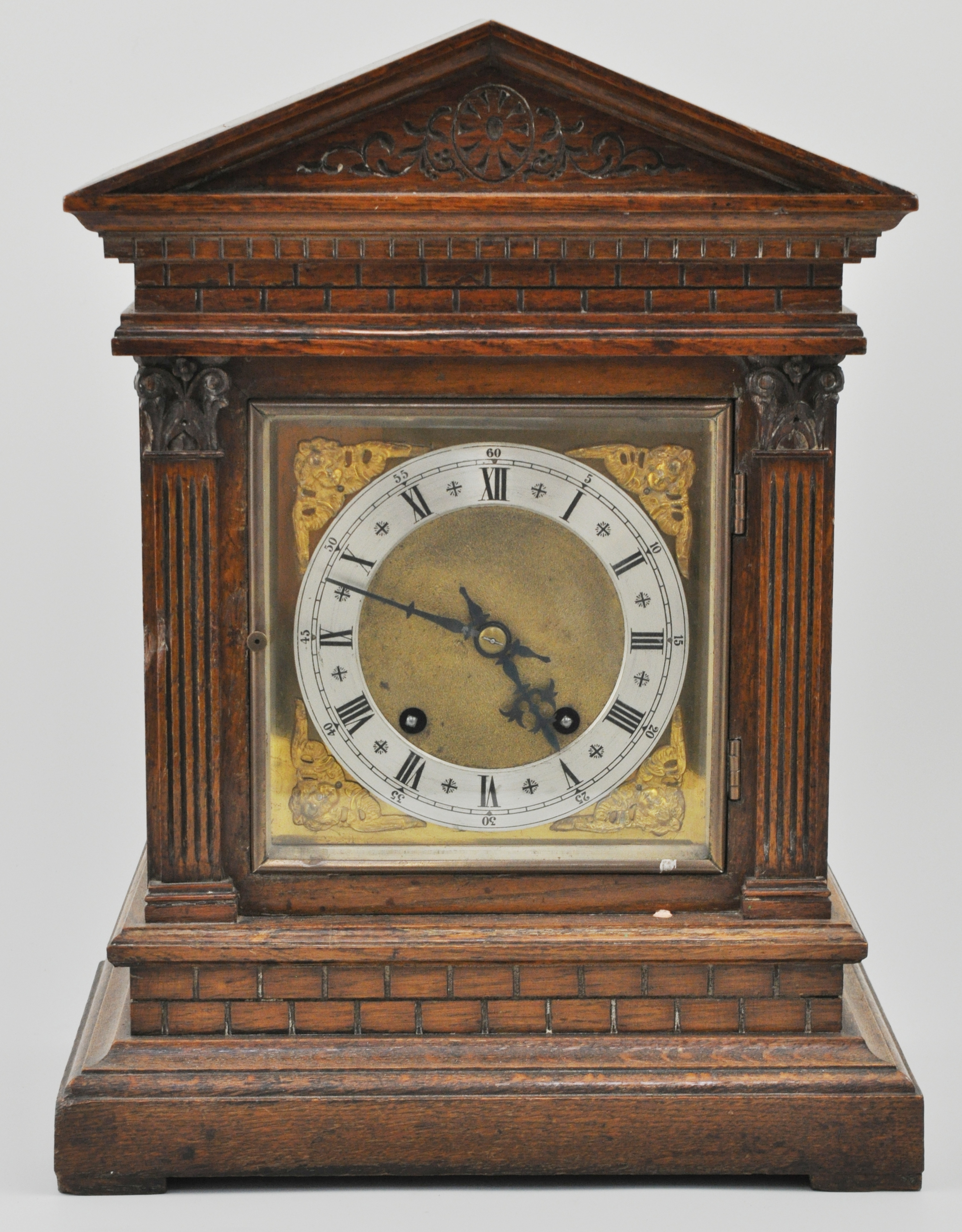 German oak cased bracket clock, with a brass dial, Roman numerals, striking on a gong, height 41cm.