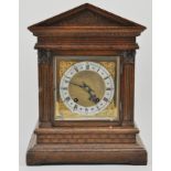 German oak cased bracket clock, with a brass dial, Roman numerals, striking on a gong, height 41cm.