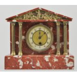 Pink veneered marble mantel clock, brass dial, flanked by four pillars, height 26cm.