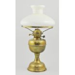 Victorian brass oil lamp and shade, a pedestal brass oil lamp with an amber shade and other lamps,