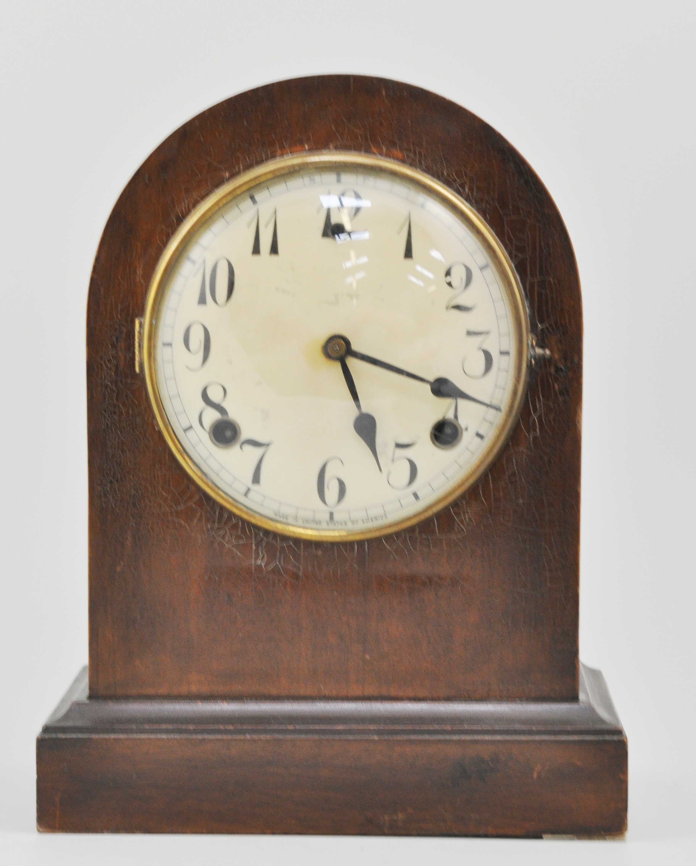 Mahogany cased domed top mantel clock, on a plinth base, height 29cm.