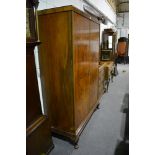 Walnut three piece bedroom suite, comprising a dressing table, arched bevelled mirror back, fitted