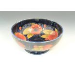 Moorcroft footed bowl, Pomegranate design on a blue ground, signature mark, diameter 21cm.