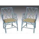 Pair of simulated bamboo elbow chairs, lemon upholstered drop in seats, width 63cm.