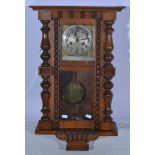 Walnut cased Vienna wall clock, square silver dial with brass spandrels, spring driven movement,