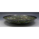 A Chinese black ground Famille Verte dished circular charger, bearing Kangxi six character mark,