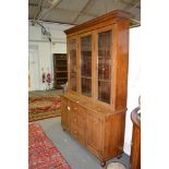 Oak bookcase cabinet, moulded cornice, three glazed doors to the upper section enclosing shelves,