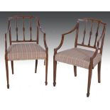 Pair of Sheraton style stained elbow chairs, with vertical rails, upholstered in striped cotton,