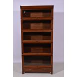 Walnut five height sectional bookcase, glazed flap fronts, single drawer under, width 87cm.