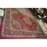 Wilton Persian pattern carpet, central medallion on a red ground, border within guards, 365cm x