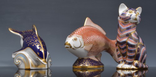 Three Royal Crown Derby paperweights, Dolphin, Trout and a Cat (3).