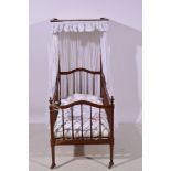 Stained wood half tester cot, with drape and covers, length 128cm.