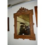 Stained and parcel gilt pier glass, with urn and laurel cresting, arched plate, 105cm x 70cm.