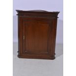 Georgian oak hanging corner cupboard, dentil cornice, key pattern frieze, panel door, height 95cm.