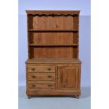 Stripped pine dresser base, fitted with a door and three drawers, width 122cm with a matched two