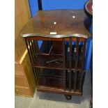 Edwardian style stained mahogany revolving bookcase, serpentine outlines, height 83cm.