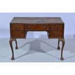 Stained wood and figured walnut writing table, serpentine shape fitted with five drawers around the