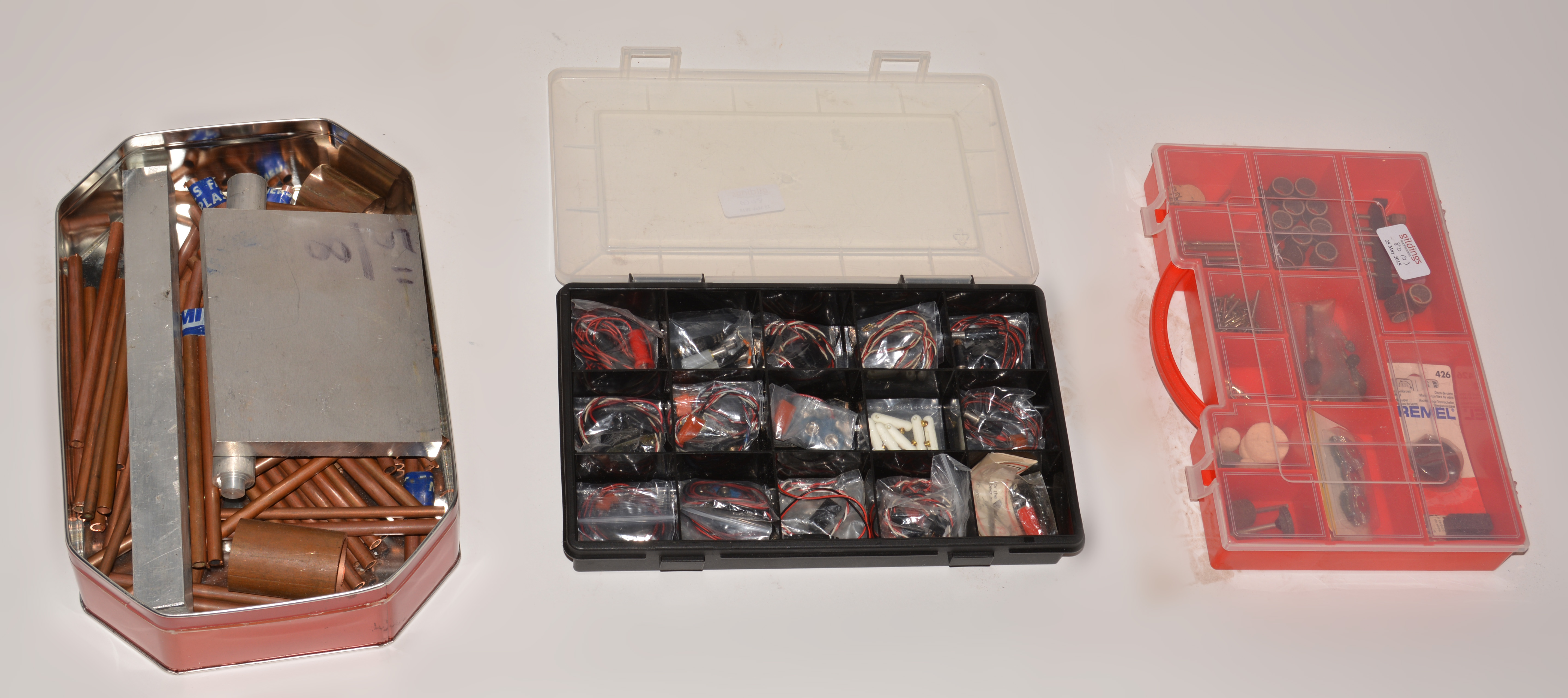 Three boxes Tin, containing copper and off cuts, plastic box with Dremel tool, box of R/C spares.