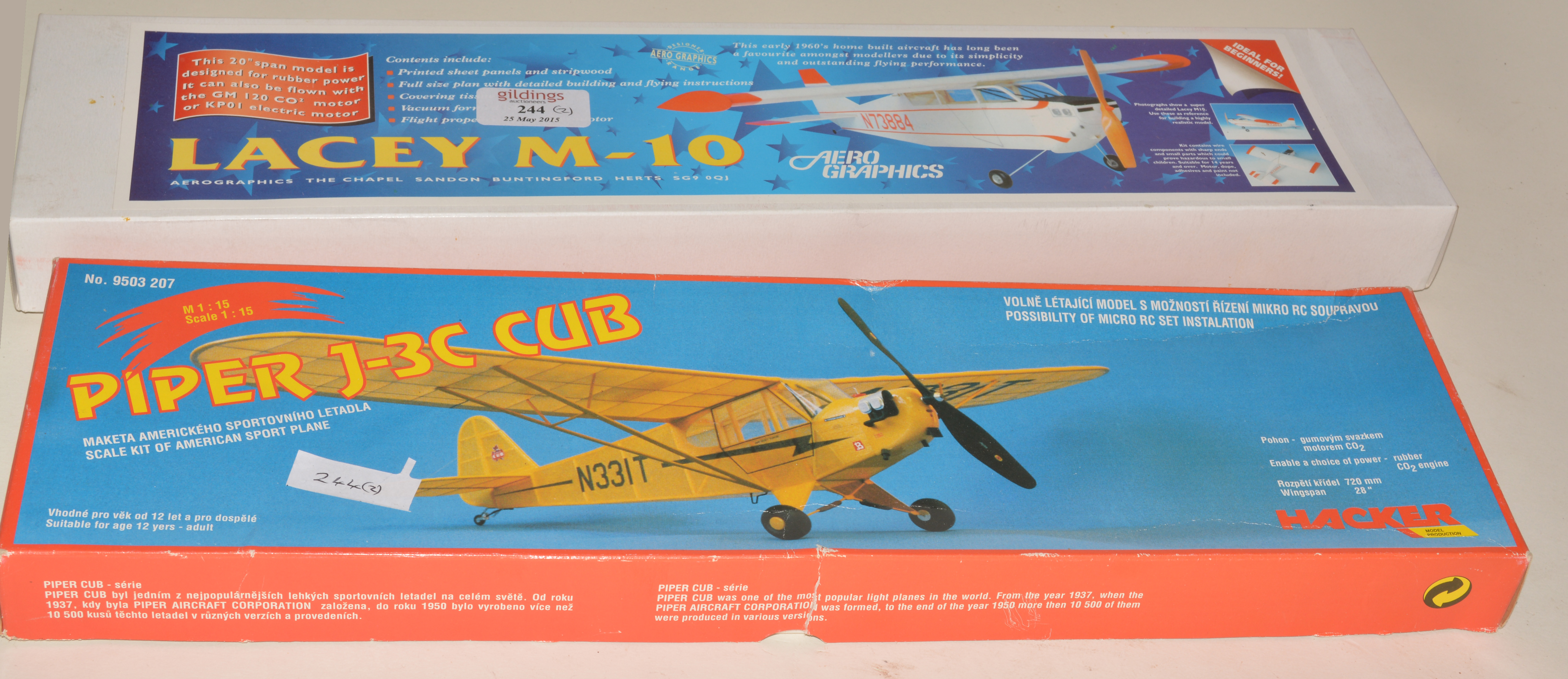 Two scale rubber kits, Piper J3 and Lacey M10.