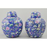 Pair of Chinese export ginger jars and covers, with a floral decoration on a blue ground,