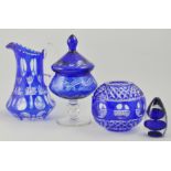 Small collection of blue tinted glassware, to include a pedestal lidded bowl, a jug, an eye bath,