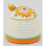 Clarice Cliff Marguerite beehive honey pot, relief moulded and decorated in orange,