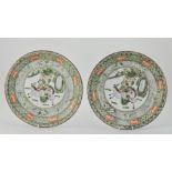 Pair of Chinese Famille Verte chargers, decorated with oriental hunting scenes,