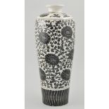 Chinese tall vase, decorated with a black stylised flower decoration on a white ground, height 35cm.