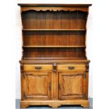 Edwardian oak dresser, canopy above a two shelf panel back, drawer and cupboard below, bracket feet,